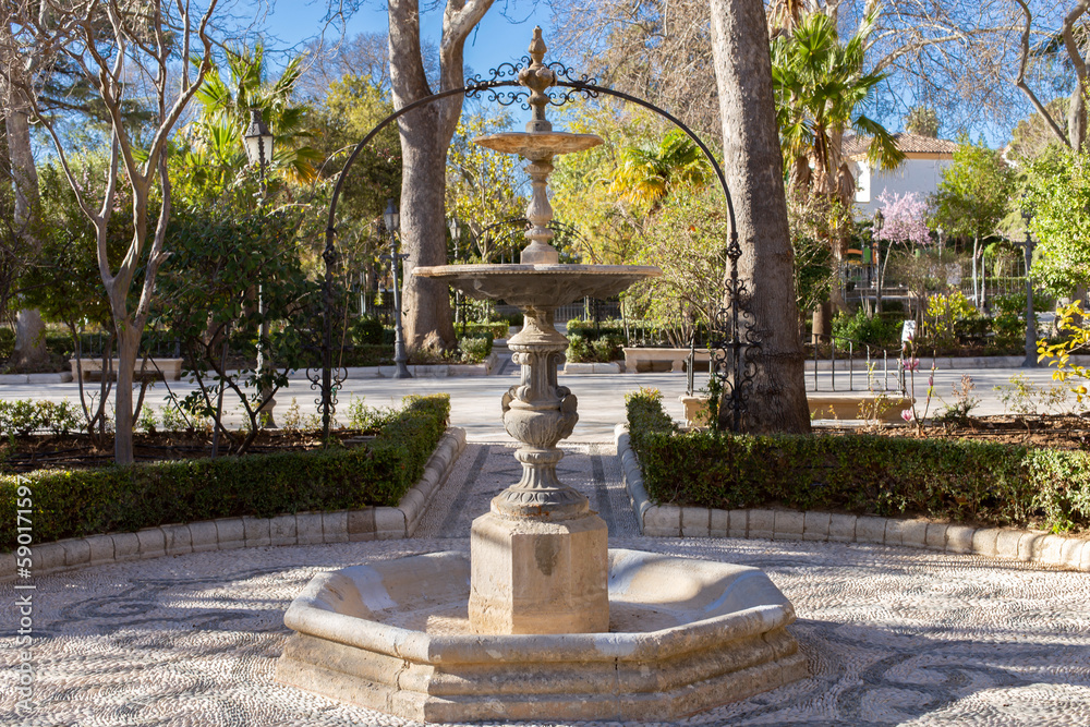 Fountain in Ronda Alameda del Tajo Park, cobblestone pattern on the floor.