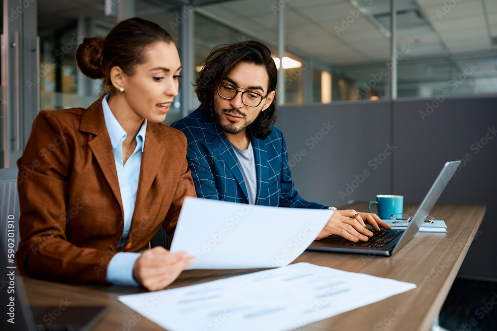Business colleagues cooperating while working together in office.