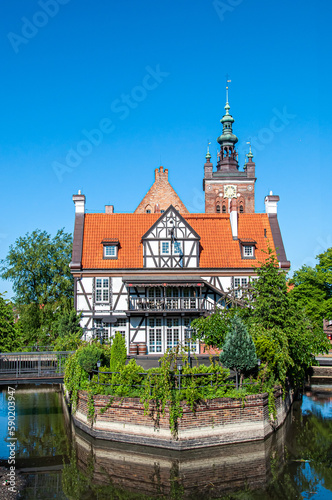 Manor of the Guild of Millers by the Radunia river in Gdansk at daylight. Poland Europe. Half-timbered building built on the north side of the island in the 19th century. Summer time.