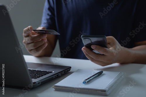 Businessman holding credit card and typing on a mobile smartphone for online shopping and payment makes a purchase on the Internet, Online payment, Business financial and technology.