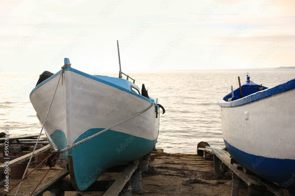 Moored boats on beach near sea outdoors
