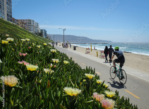 People walk and cycle along the Marvin Braude bike trail in Redondo Beach on a beautiful spring afternoon.  photo