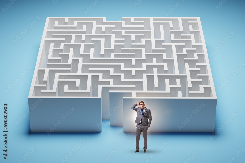 Businessman trying to find a way out of maze Businessman trying to find a way out of maze