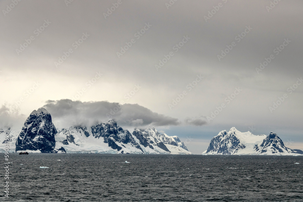 Sailing between mountains in the Neumayer Channel in Antarctica