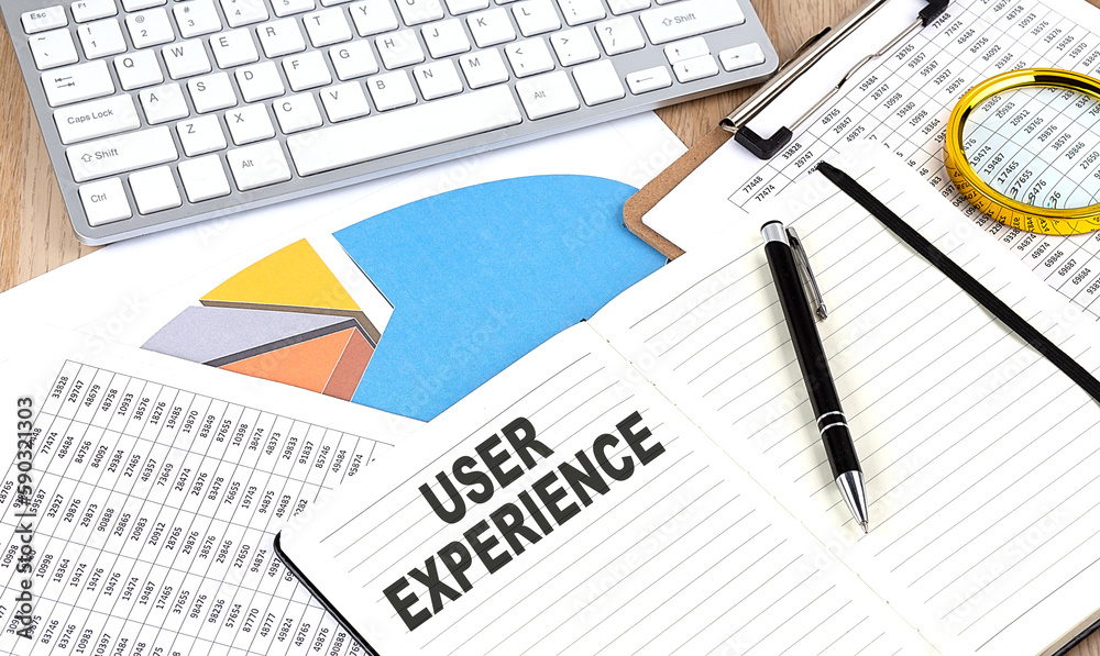 USER EXPERIENCE text on a paper on chart background USER EXPERIENCE text on a paper on chart background
