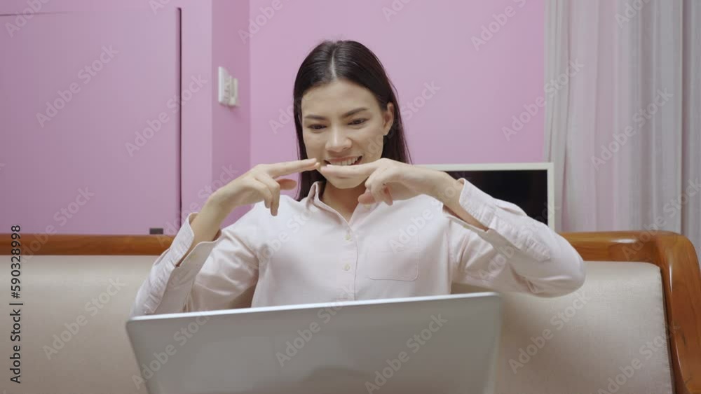 Beautiful mute woman using sign language to communicate via video call on laptop, wireless technology, 5G.