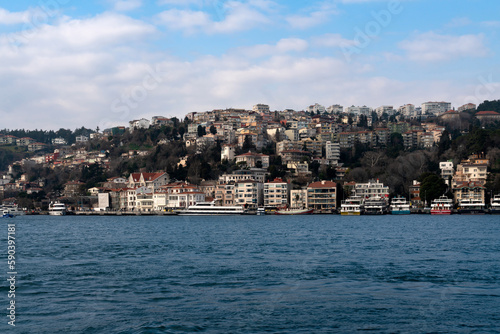 View of the Arnavutkey district of Istanbul on the European part of the city behind the Bosphorus Bridge from the water area of the Bosphorus on a sunny day, Istanbul, Turkey