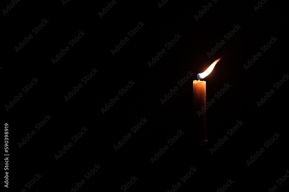 Illuminated candle seen in dark room Illuminated candle seen in dark room