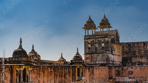 Ancient weathered walls with watchtowers, domes, spires against the blue sky. Amber Fort. India. Jaipur