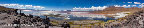 Scene of salt lagoon reflecting mountains and clouds as if in a mirror.