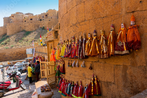 Jaislamer fort, Rajasthan, India - 13.10.2019 : Traditional King and queen, called Raja Rani, handmade puppets or Katputli Sets are hanging from wall. Dolls in Jaisalmer are popular, sold to tourists. © mitrarudra