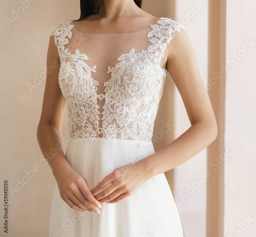Tablou canvas Front view of beautiful bride in the white wedding dress with deep neckline