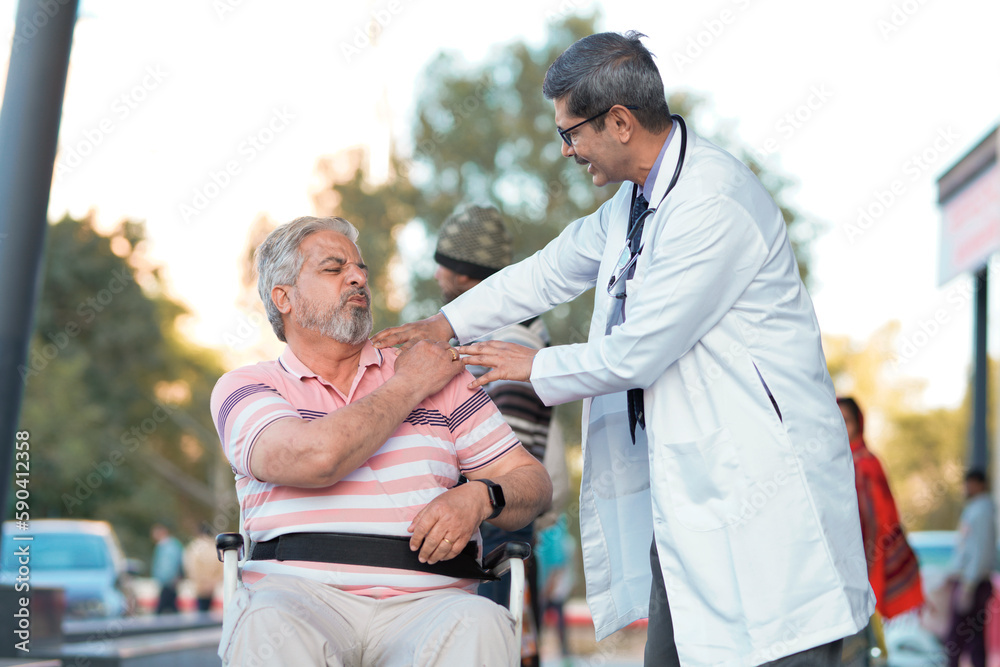 Fototapeta premium Doctor checking to old man while he is moaning in pain.