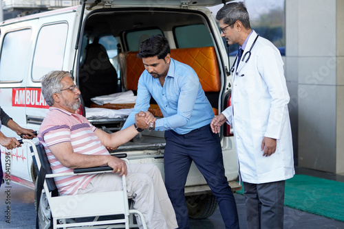 Doctor checking to old man while he is moaning in pain.