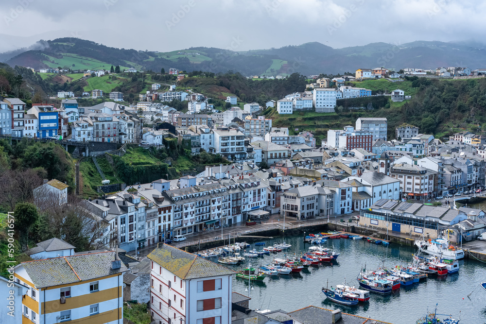 Fishing port with small fishing boats at the foot of the picturesque town of Luarca, Asturias.