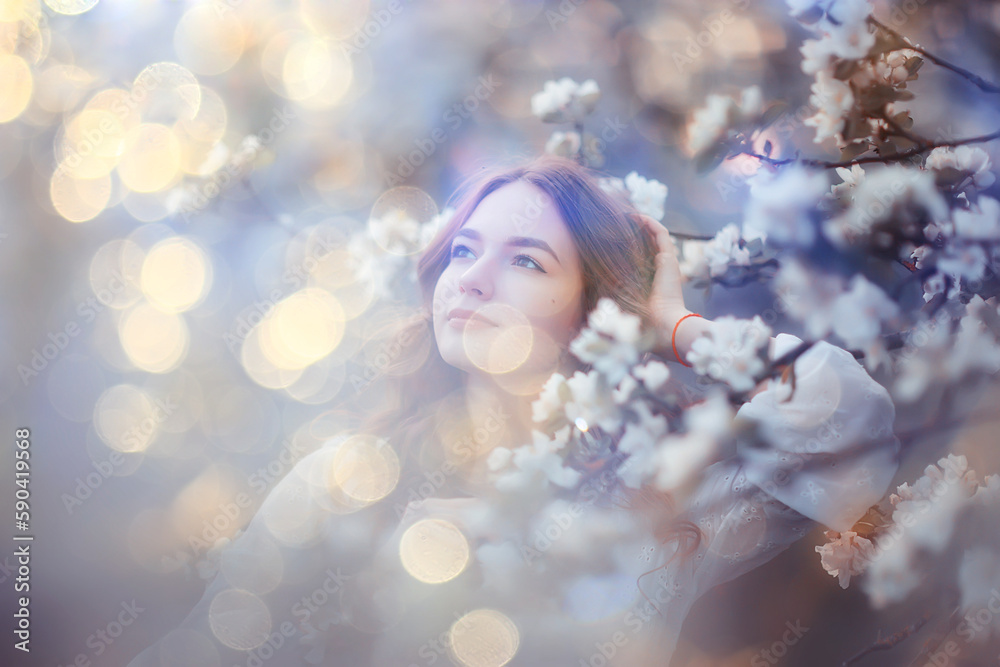 spring portrait of an adult happy woman in a blooming garden, sun rays and glare, april flowers girl spring portrait of an adult happy woman in a blooming garden, sun rays and glare, april flowers girl