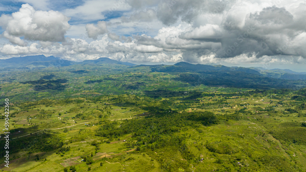 Aerial view of mountain landscape with green hills and farmland. Negros, Philippines