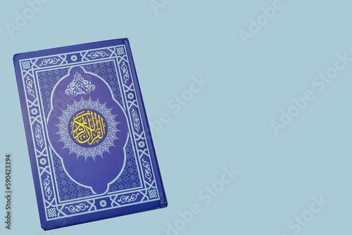 Holy Al Quran with written arabic calligraphy on white background with copy space