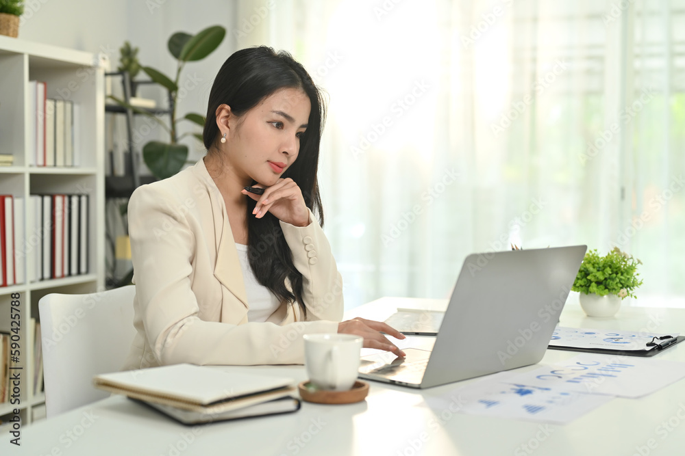 Attractive asian female entrepreneur chatting with client online, communicating on internet via laptop computer Attractive asian female entrepreneur chatting with client online, communicating on internet via laptop computer