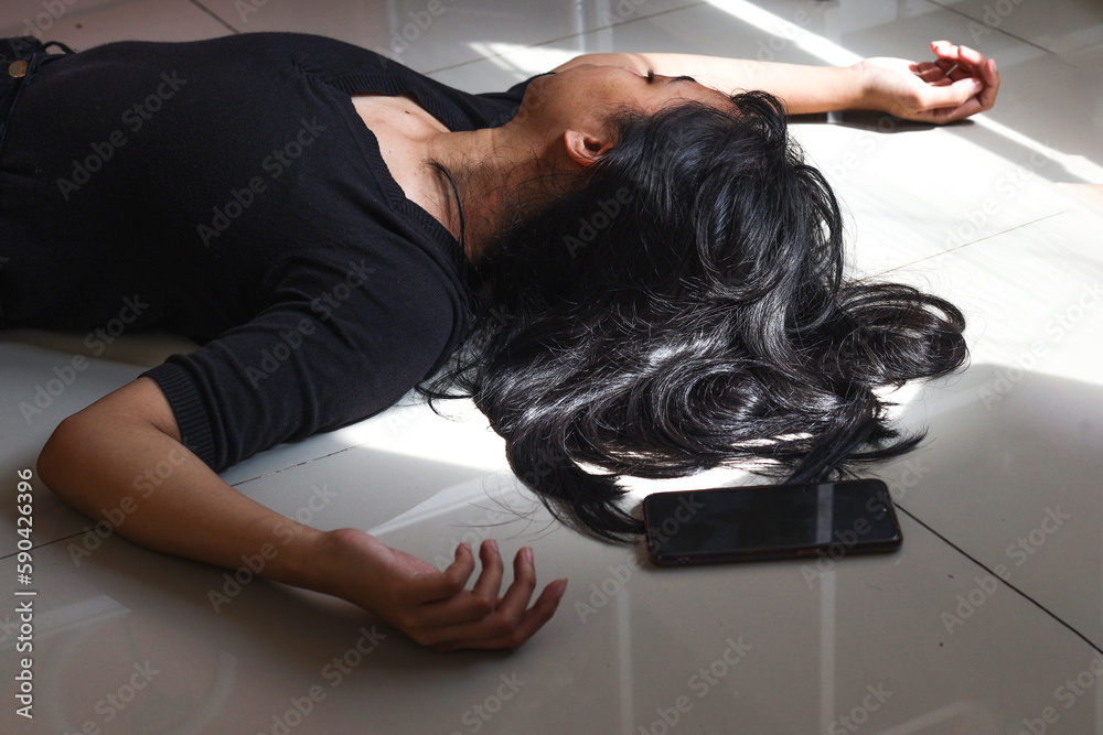 Woman lying on the floor at home, phone fallen near her hand. Woman lying on the floor at home, phone fallen near her hand.