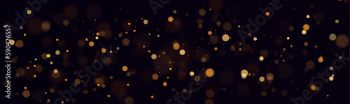 Golden abstract bokeh on black background. Christmas or holiday card decoration