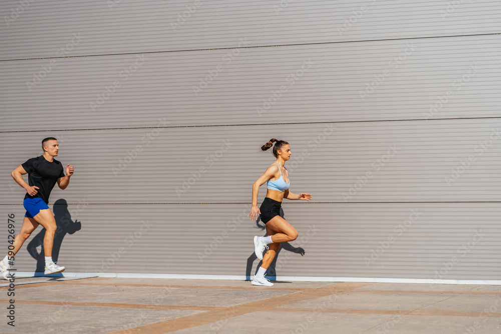 An attractive couple exercising outside