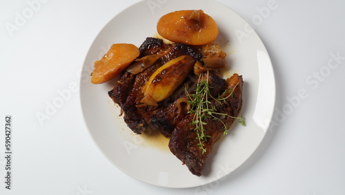 A steak braised herbs, served with boiled potatoes garnished with fresh oregano.