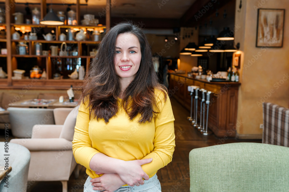 Young woman with long hair in a beautiful restaurant with lamps and chairs Young woman with long hair in a beautiful restaurant with lamps and chairs