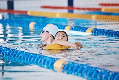 Swimming pool rescue, or woman with lifeguard for emergency, drowning accident or dangerous activity. Fitness training, breathing or strong person saving life of girl swimmer or victim in water