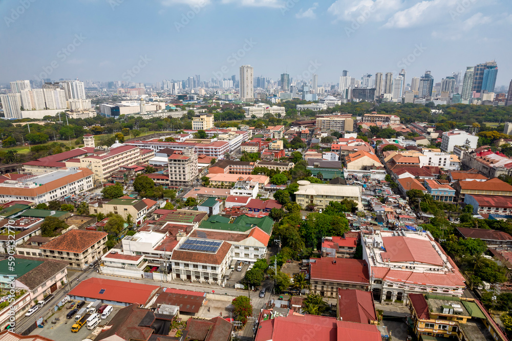 Manila, Philippines - Aerial of the walled city of Intramuros, and distant condos in Ermita district.