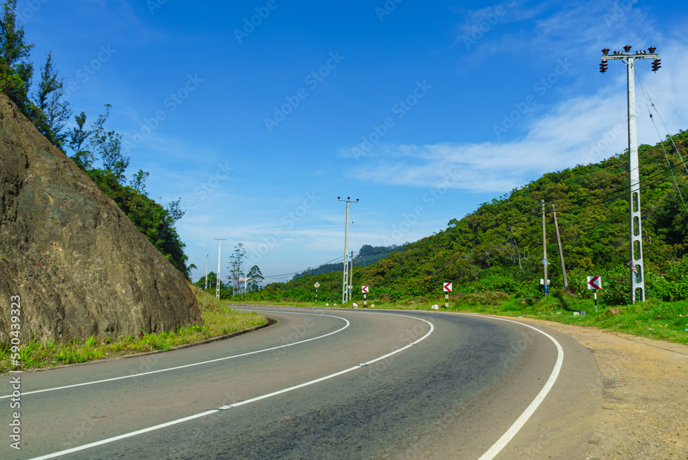 Serpentine asphalt road in the mountains and blue sky