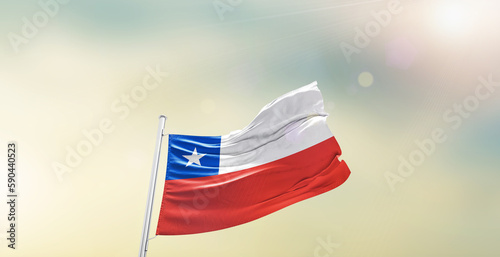 Waving Flag of Chile on blur sky. The symbol of the state on wavy cotton fabric.