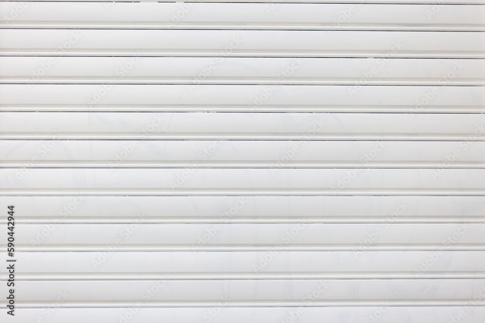 Modern empty white roller shutter door background texture. Metal closed garage door. Copy space Modern empty white roller shutter door background texture. Metal closed garage door. Copy space