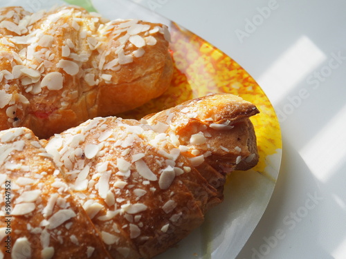 croissant on a plate on the table next to the window