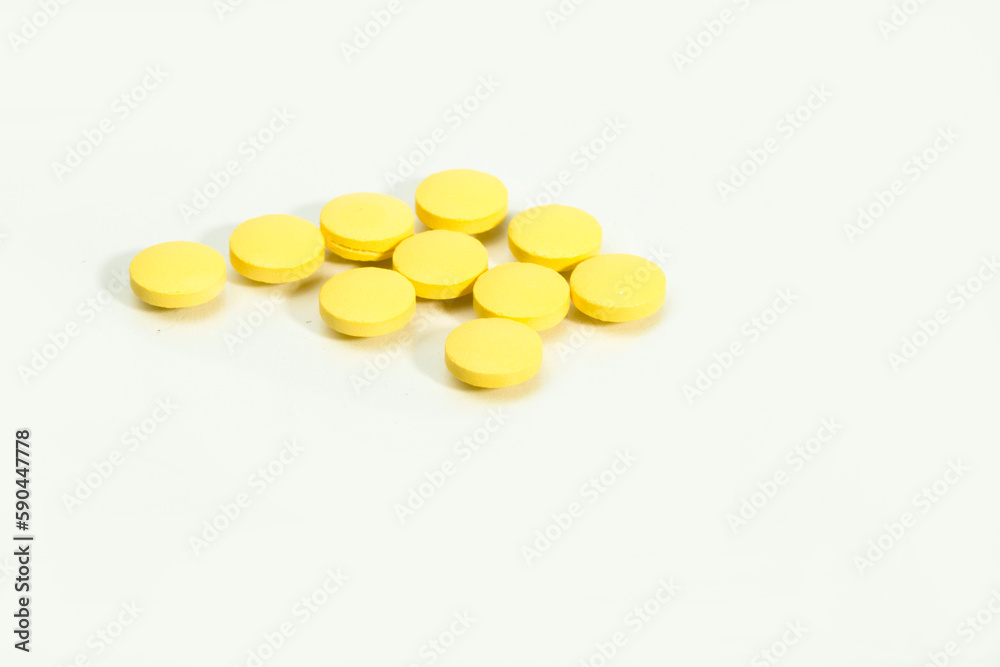 Close up shots of medicine tablets and capsules on white background. White and colored tablets placed in a group. Close up shots of medicine tablets and capsules on white background. White and colored tablets placed in a group.