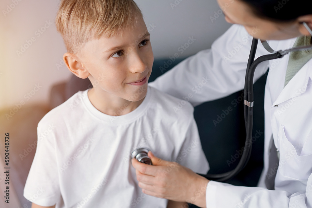 Happy smiling child patient at usual medical inspection. Doctor and kid boy at home. Medicine, healthcare concepts Happy smiling child patient at usual medical inspection. Doctor and kid boy at home. Medicine, healthcare concepts