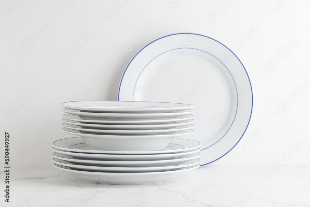 Clean white dinner plates on a white background Clean white dinner plates on a white background
