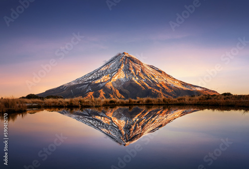 Mt Taranaki / Mt Egmont in the Egmont National Park in New Zealand during sunset behind a reflection pool © Sven Taubert