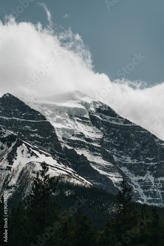 Beautiful view of a snowy mountain with a cloudy sky background