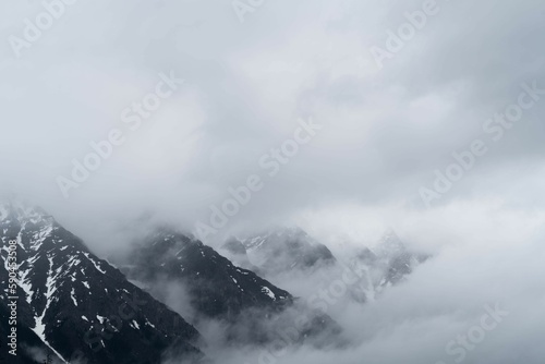 Beautiful view of a snowy mountain covered in fog