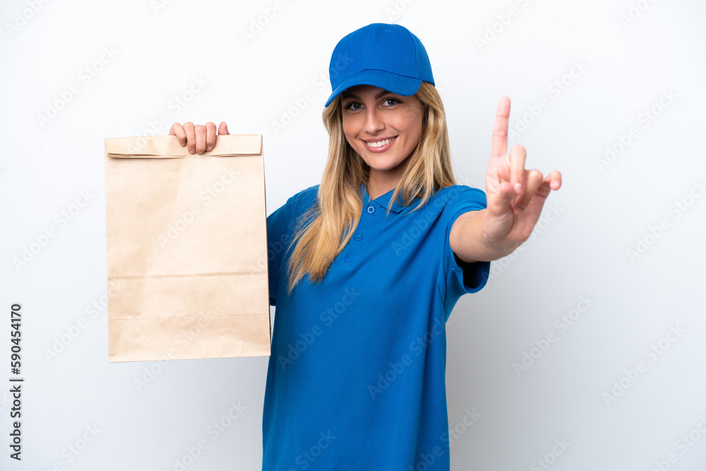 Young Uruguayan woman taking a bag of takeaway food isolated on white background showing and lifting a finger Young Uruguayan woman taking a bag of takeaway food isolated on white background showing and lifting a finger