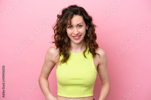 Young caucasian woman isolated on pink background laughing
