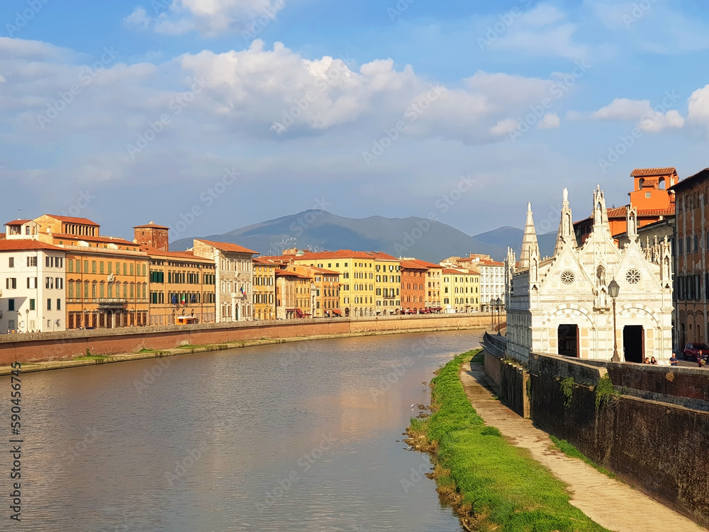 Cityscape of the colorful street of the city of Pisa with the river and Church of Santa Maria della Spina.