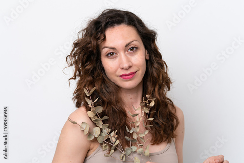 Young caucasian woman isolated on white background holding a eucalyptus branch. Close up portrait