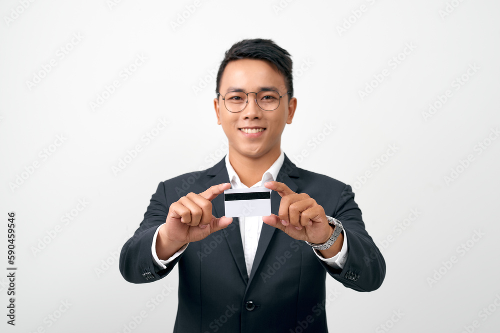 Photo of stylish handsome young man holding credit card isolated on white background Photo of stylish handsome young man holding credit card isolated on white background