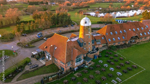 Aerial view of The Caldecotte - Pub & Grill building at sunset photo