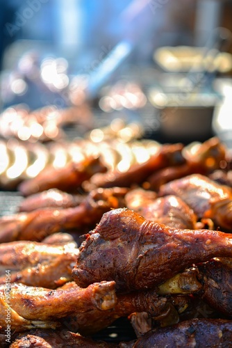 many chicken are cooking on the bbq grill with sauce