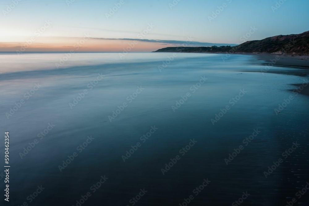 Shore and the calm ocean during scenic sunset, Port Willunga, Australia