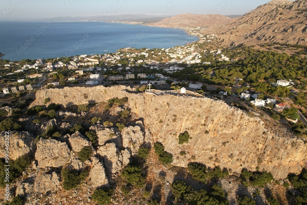 Aerial view of a town on the rocky shore with a blue sky in the background, Rhodes, Greece