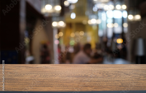 Empty dark wooden table in front of abstract blurred bokeh background of restaurant . can be used for display or montage your products.Mock up for space.